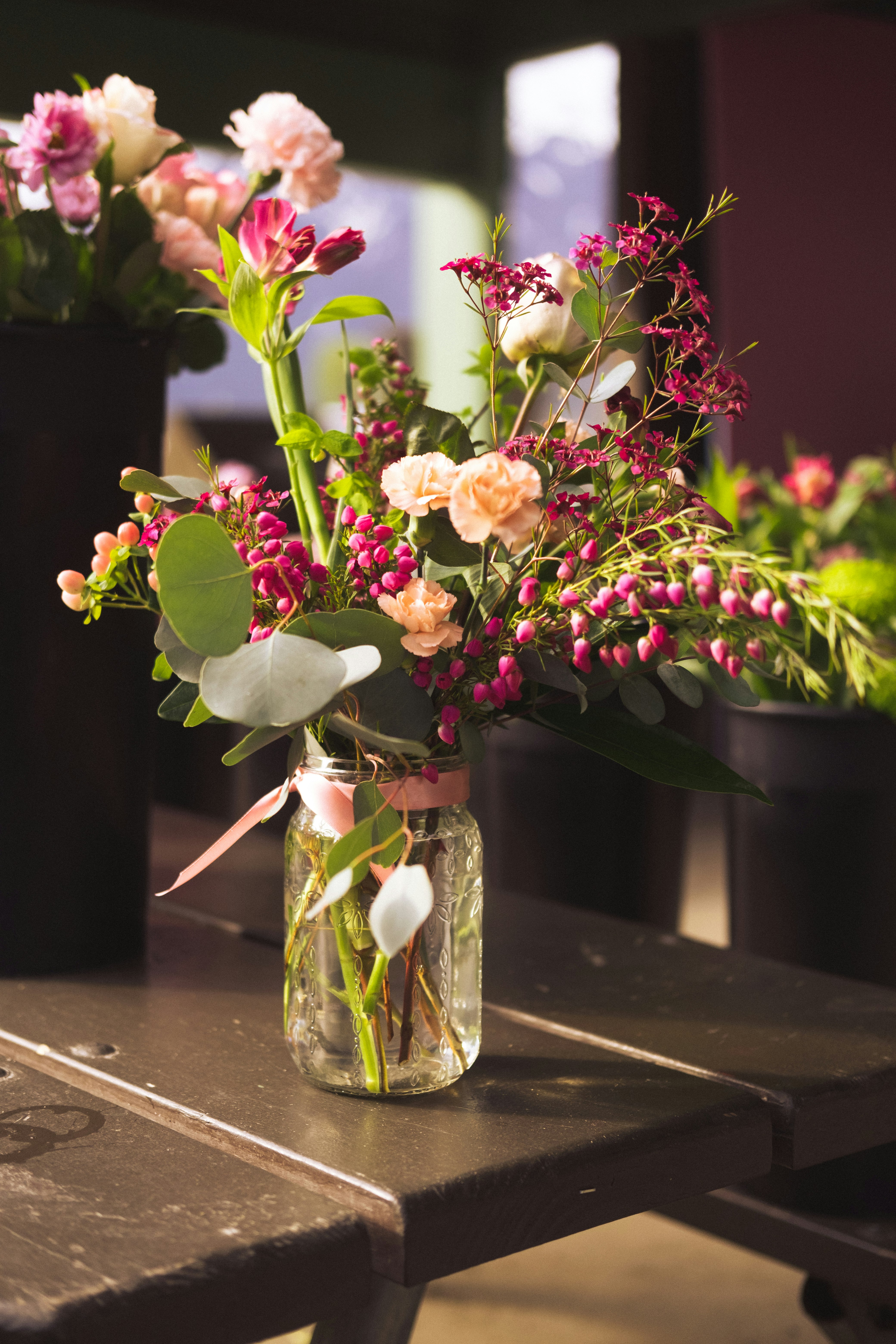 pink and white flowers in clear glass vase